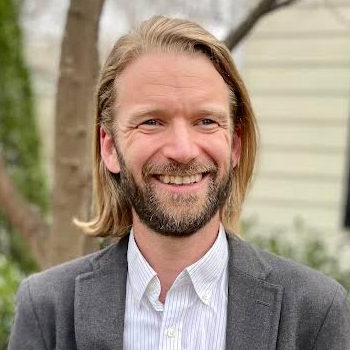 Bearded man with shoulder length blonde hair.
